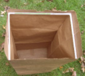 The Mulchmate holds a yard waste paper bag open and upright
